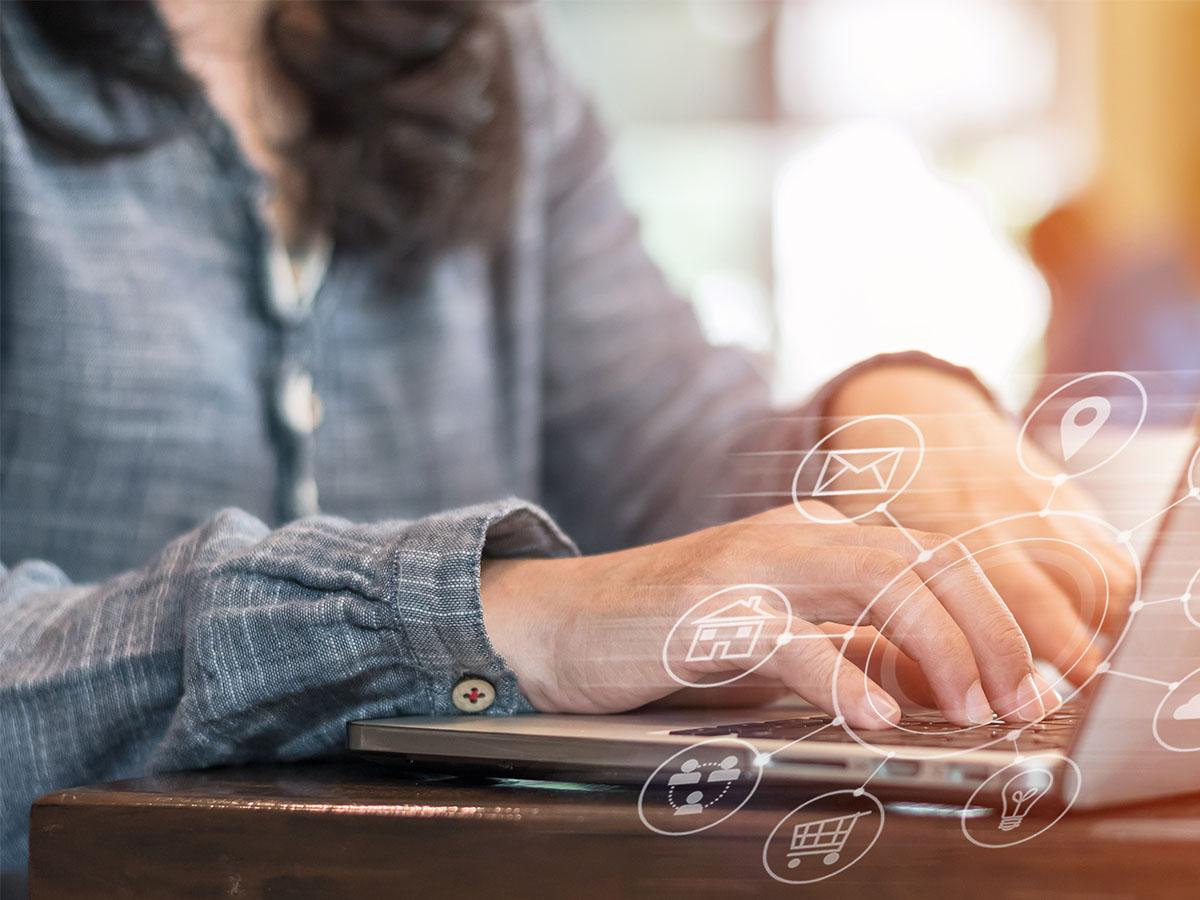 Woman typing on a laptop.