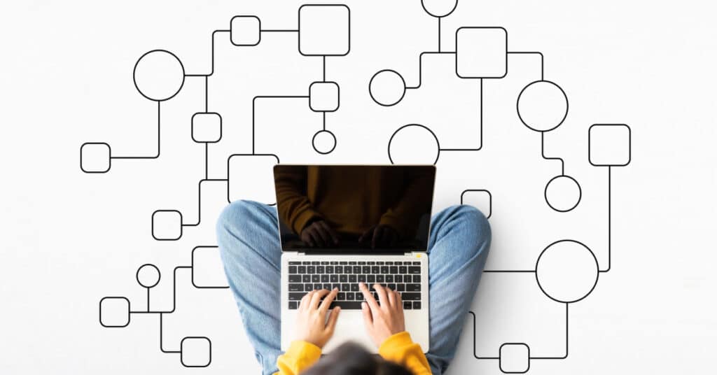 Woman building her email marketing flow chart on a laptop.