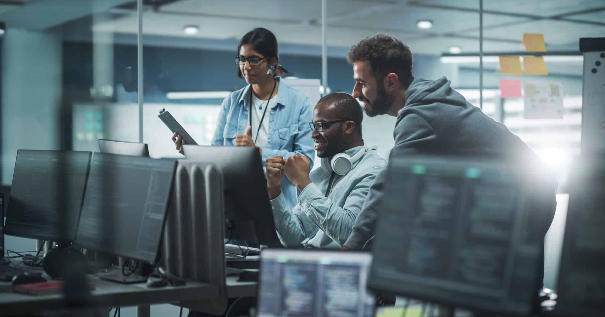 A diverse team of tech workers discovering the history of marketing automation.