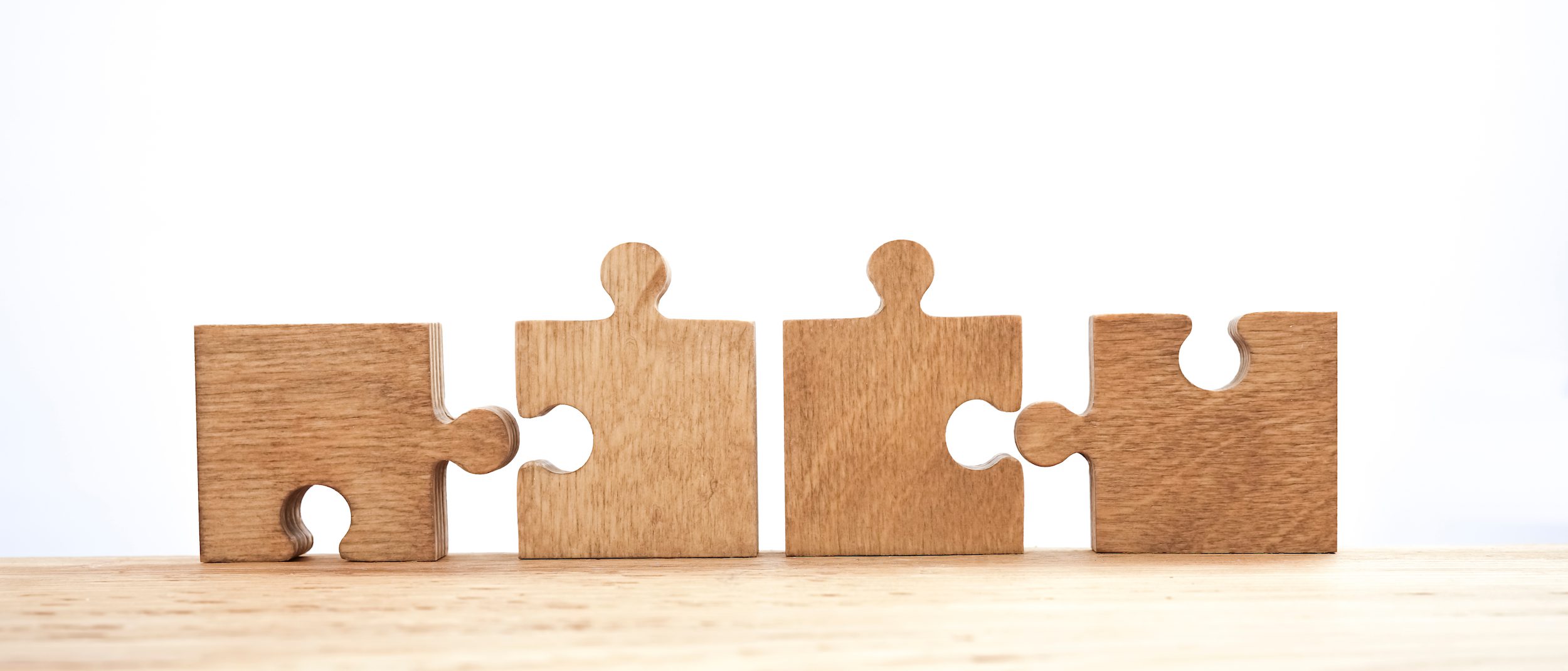Marketing automation and CRM integration illustrated by puzzle pieces fitting together.