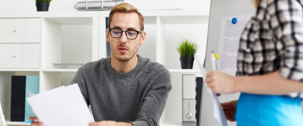 Man sorting privacy related paperwork in an office.