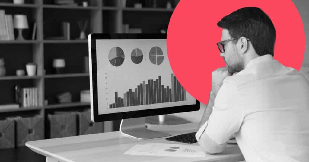 An individual uses a desktop computer to compare Marketo vs Pardot.