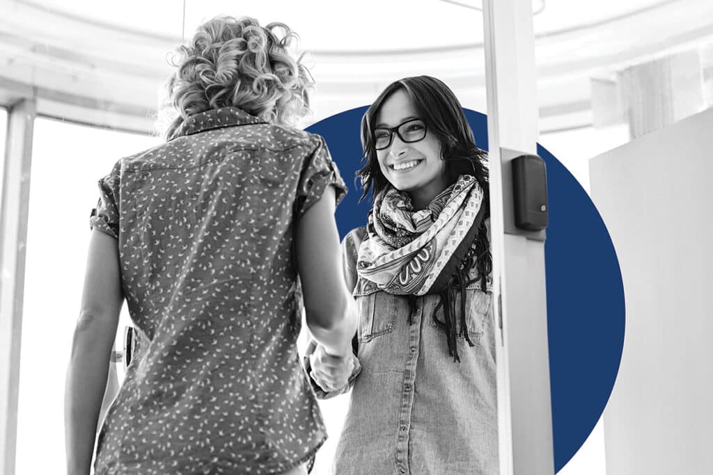 Two women engaged in native language marketing.