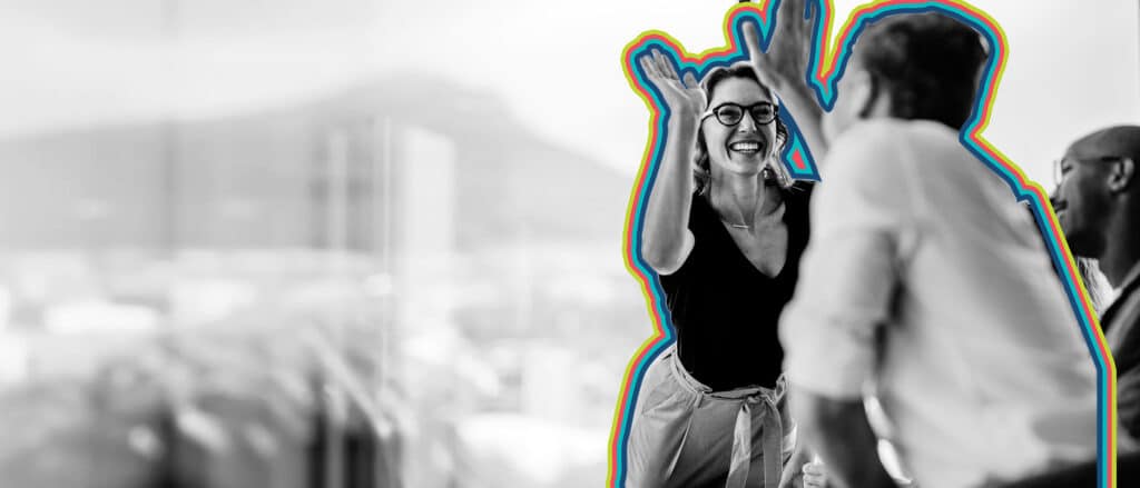 Two colleagues celebrate success with sales enablement best practices.