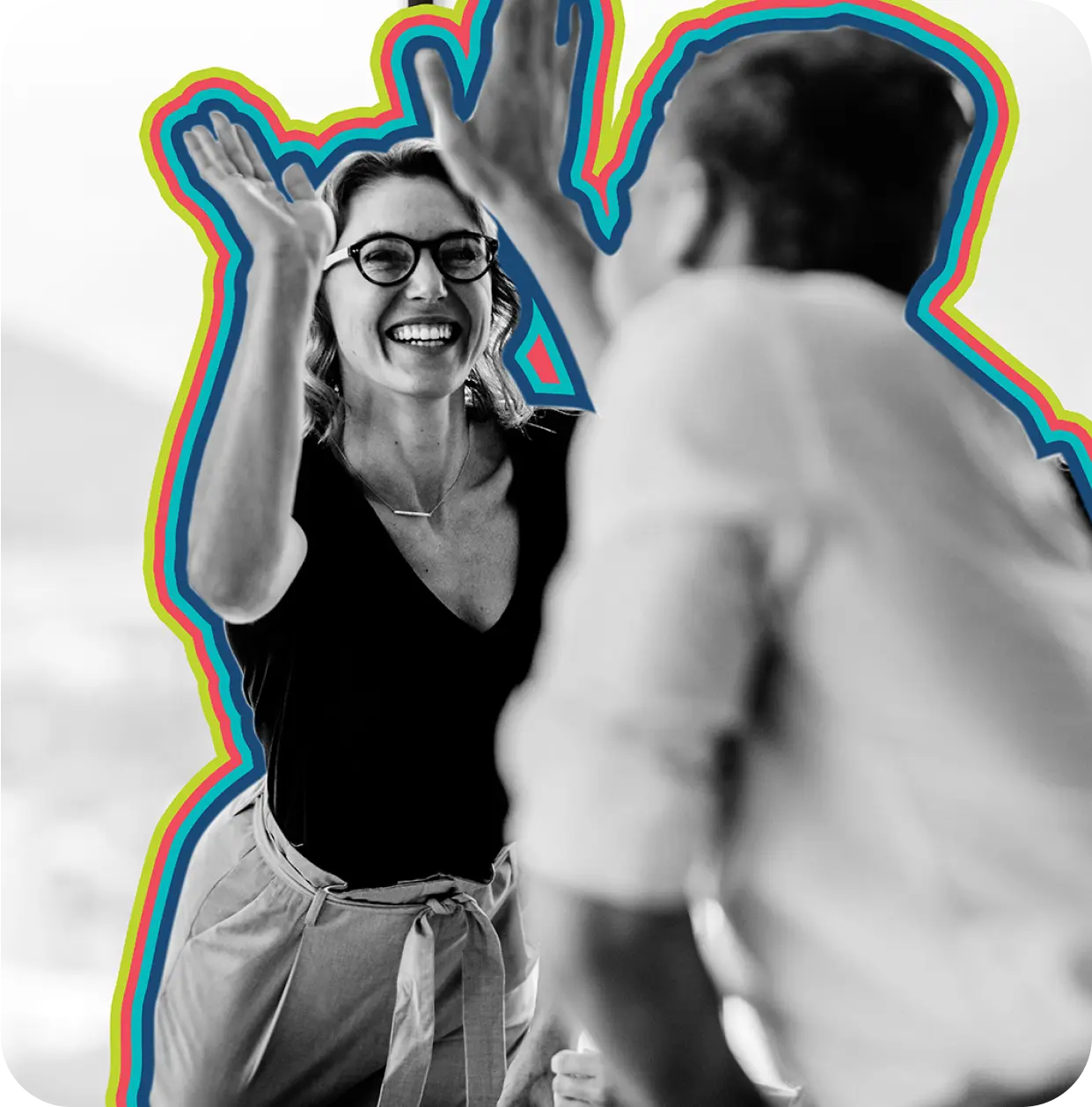 Two employees giving each other a high five.