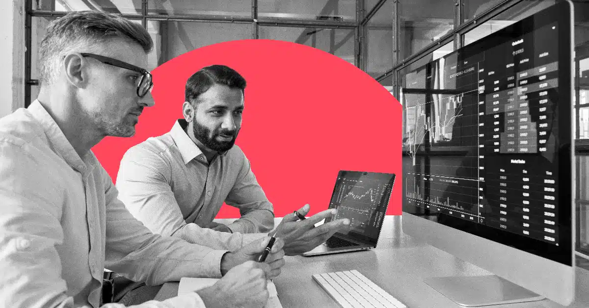 two marketing colleagues collaborate on a PC to illustrate data driven marketing