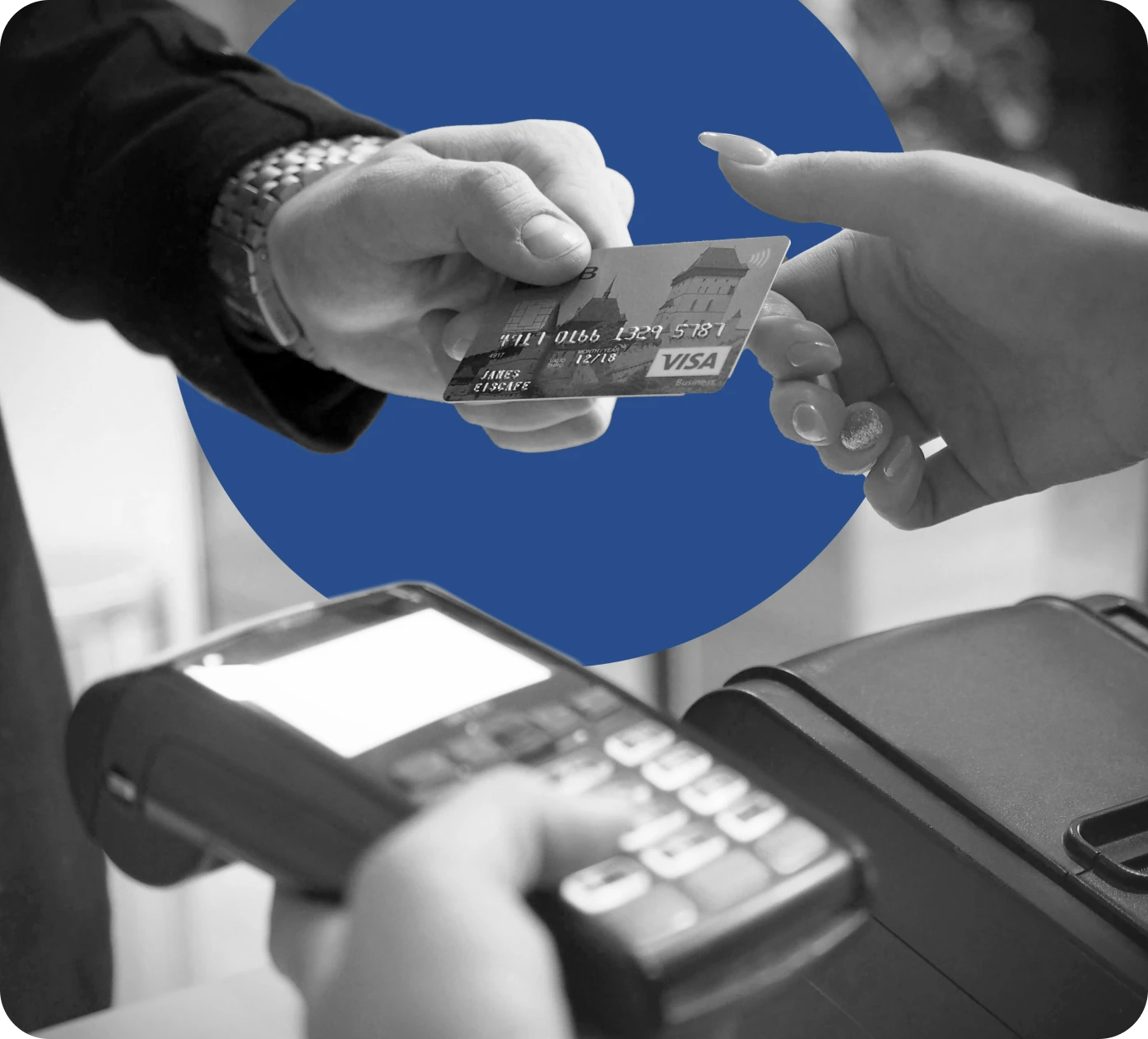 Person handing their credit card over to complete a purchase.