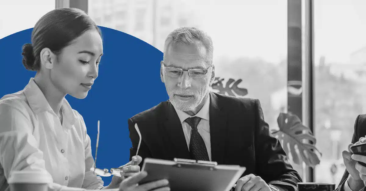 A senior and junior professional collaborate on internal communications.