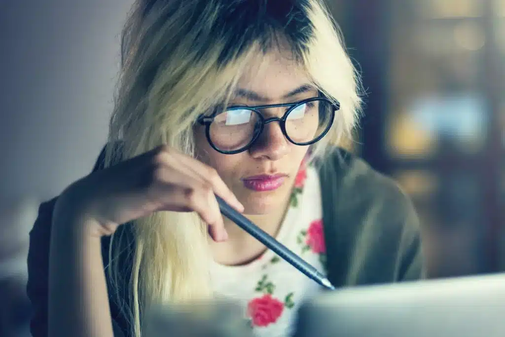 Woman reading SEO FAQ's on her computer.